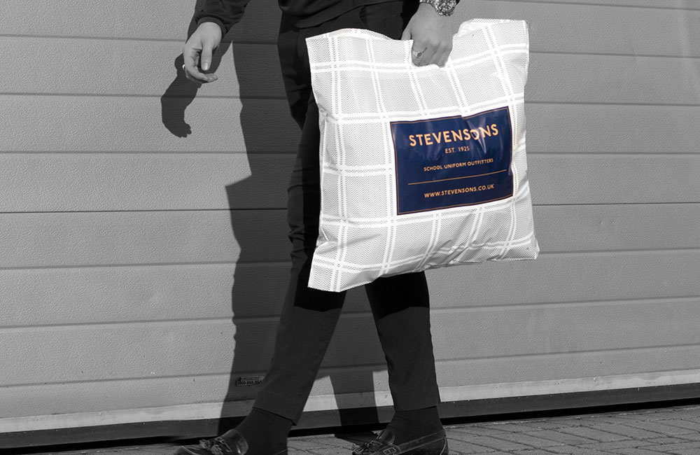 Stevensons School Uniform Outfitters man with carrier bag