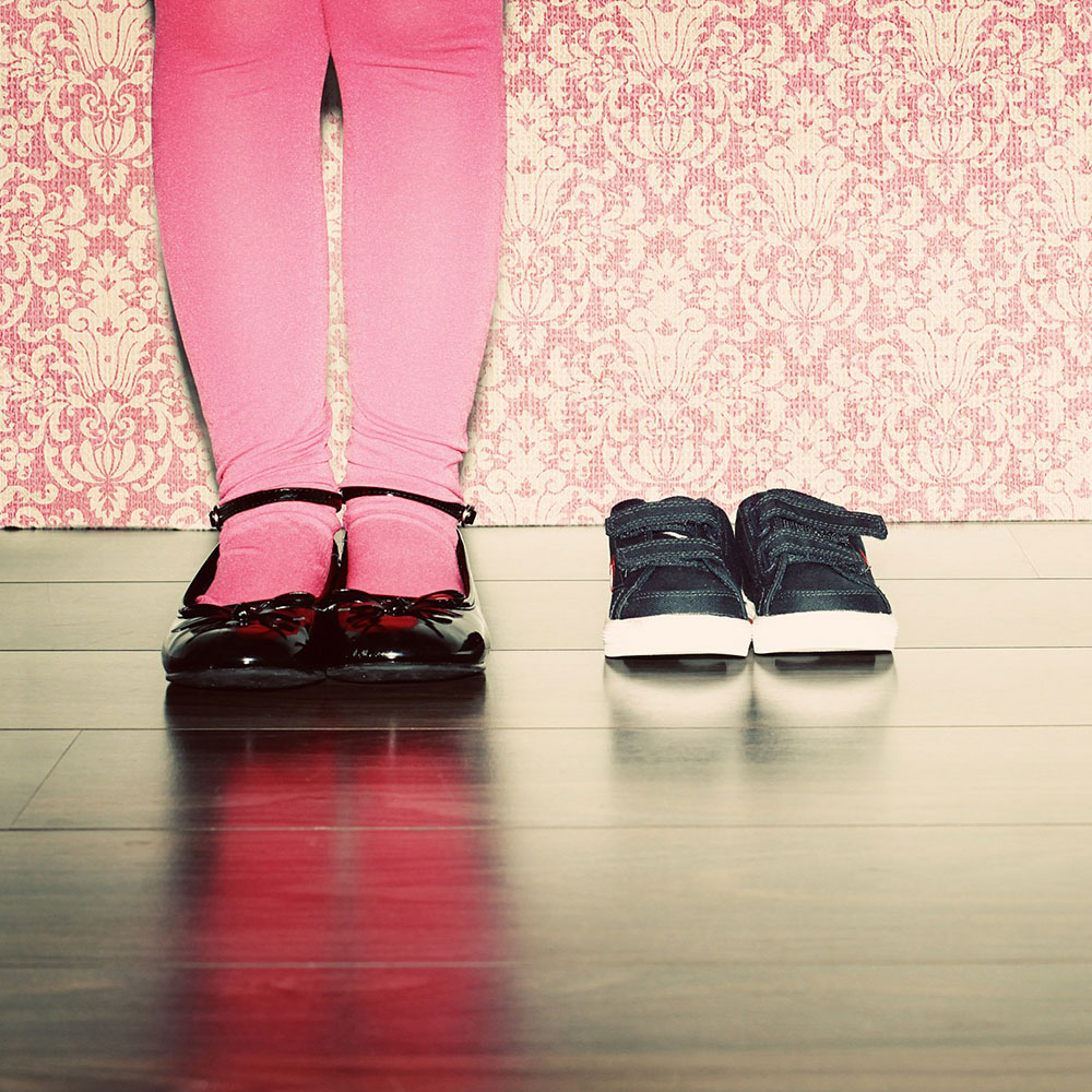 Girl in pink tights and black shoes