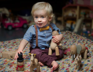 Young child with Plaay wooden toys