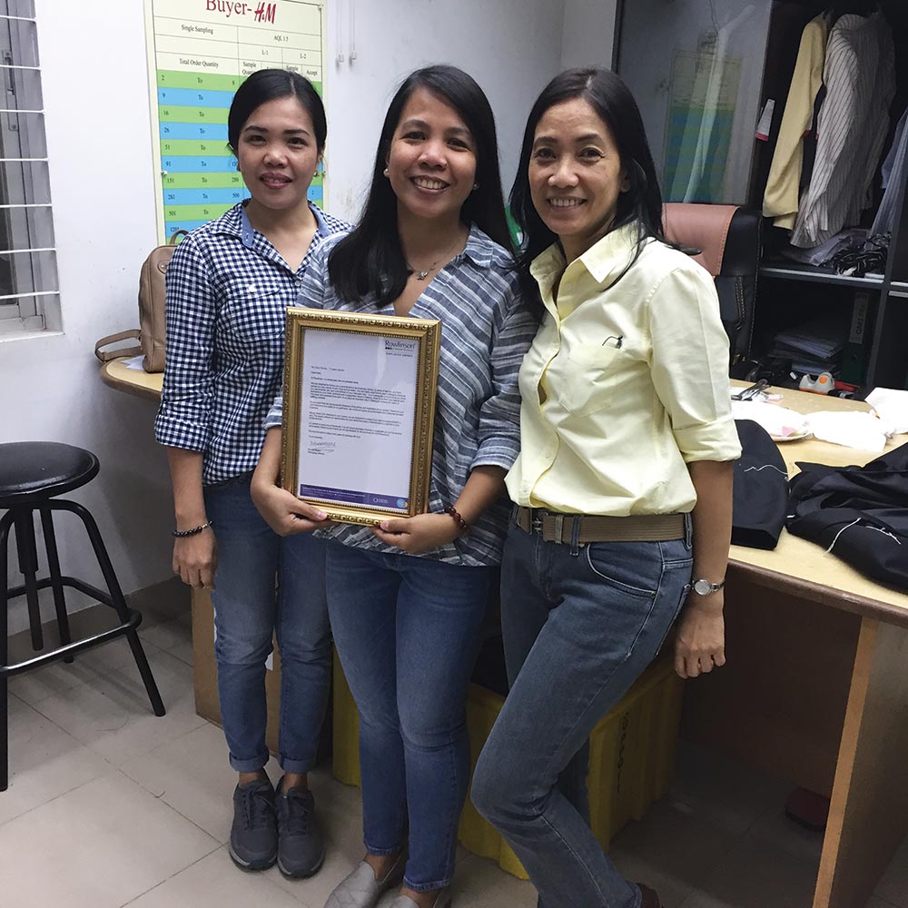 Three employees of Rowlinson holding certificate