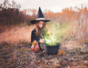 Young girl in Halloween witch costume