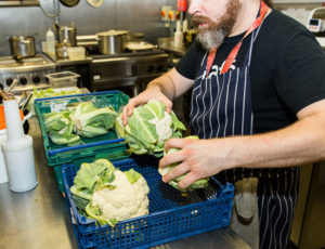 Chef sorting through cabbages for FareShare