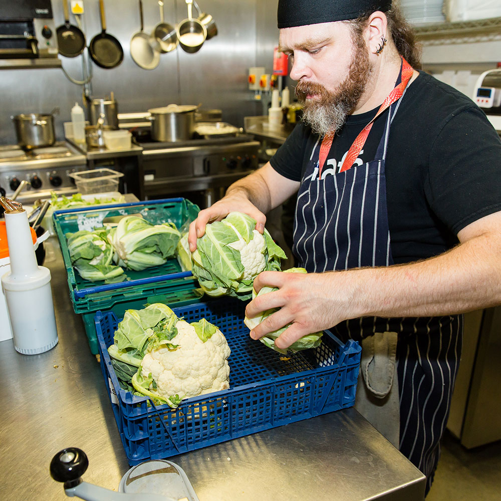 Chef sorting through cabbages for FareShare