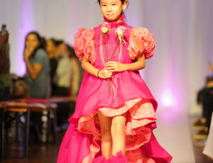 Mini Mode - Global Kids Fashion Week girl in red dress on catwalk