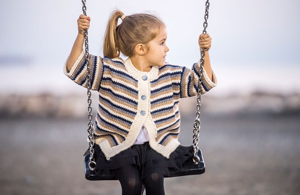 Young girl on a swing