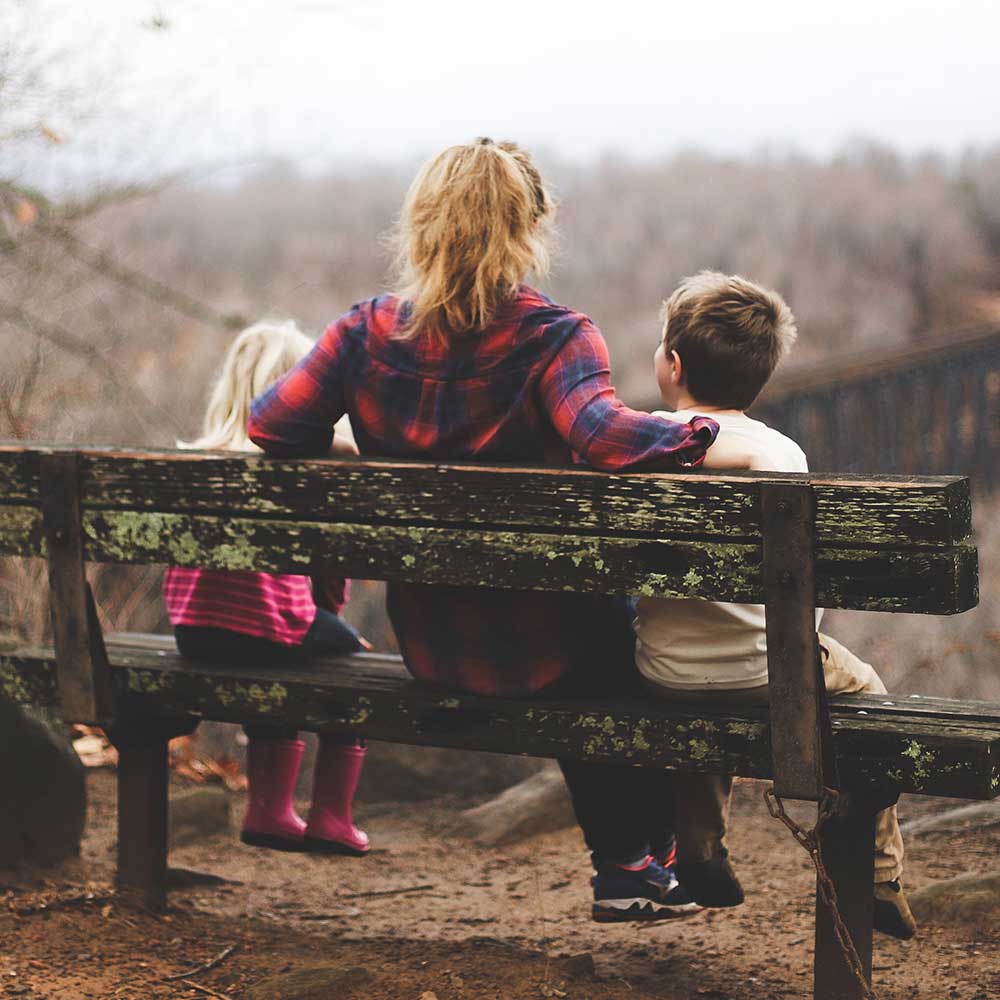 Gen Z PArenting images of mum and children sitting on a bench
