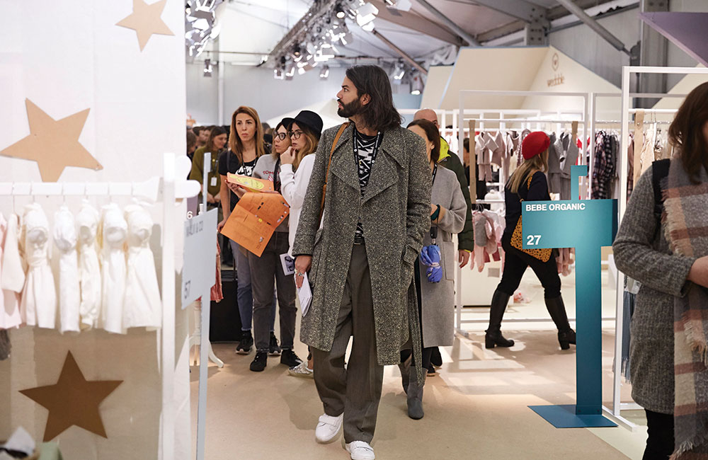 Man walking around the busy Pitti Bimbo aisles