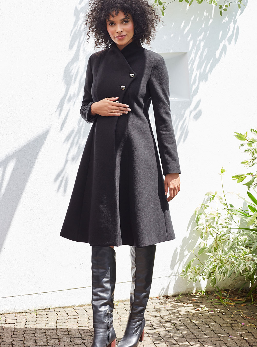 Woman in black Isabella overcoat and black boots