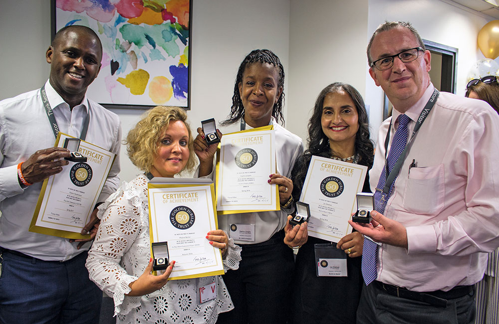 volunteering programme winners holding their certificates