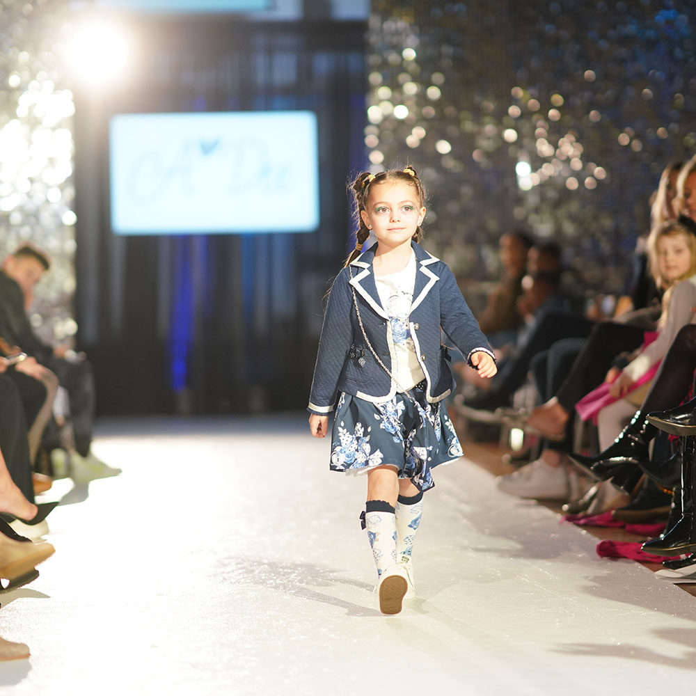 Young girl on fashion week kids catwalk