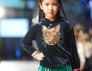 Young kids on catwalk at fashion week