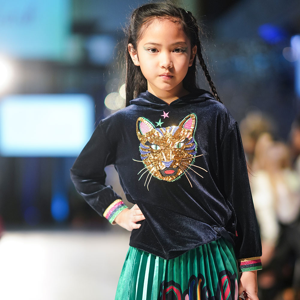 Young kids on catwalk at fashion week