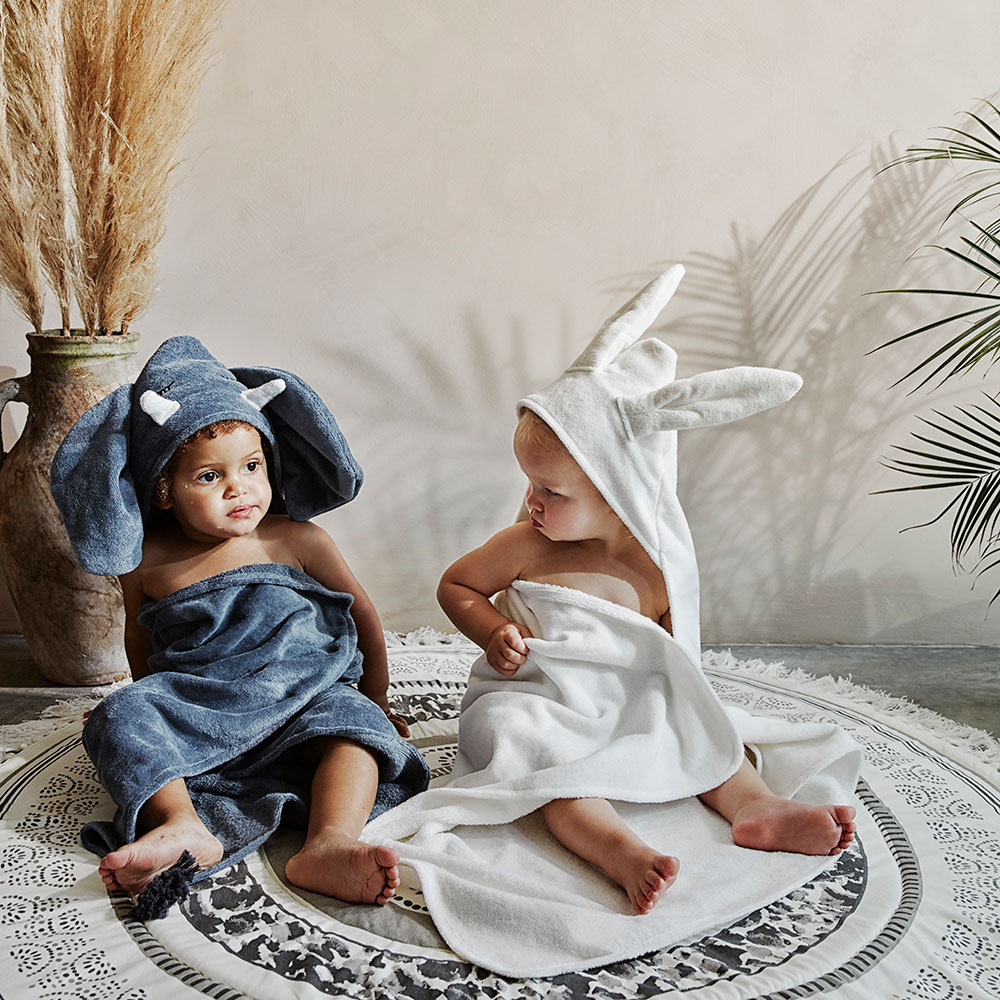 2 young children sat on a mat in Elodie towels