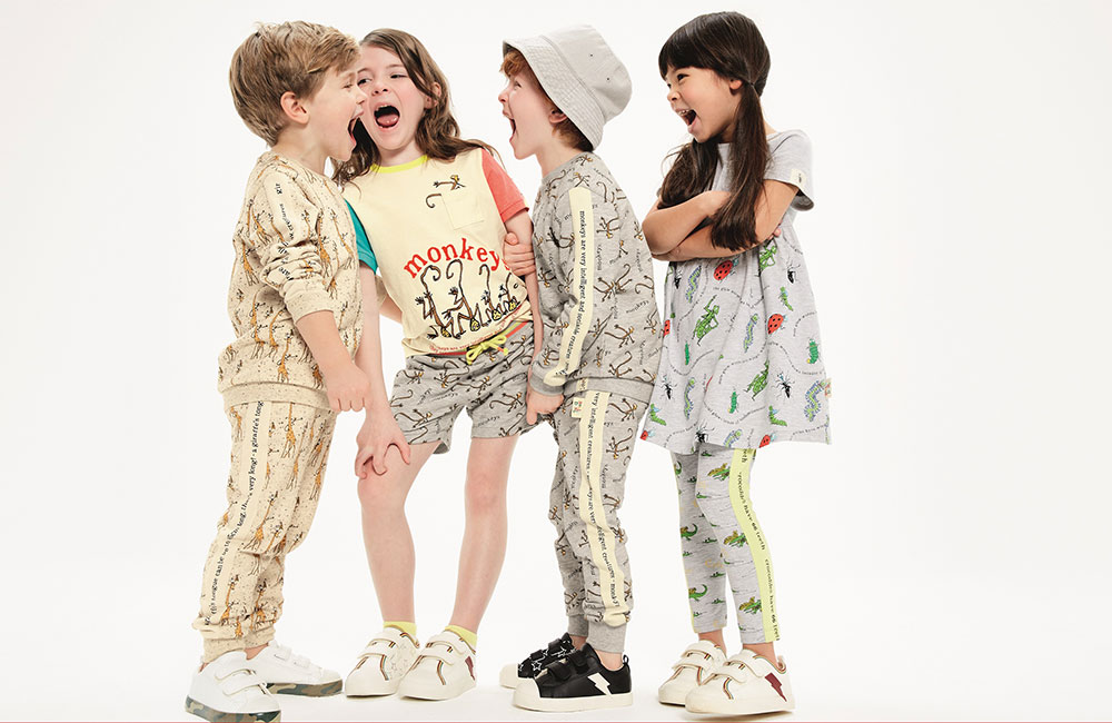 Four children in M&S clothing laughing together