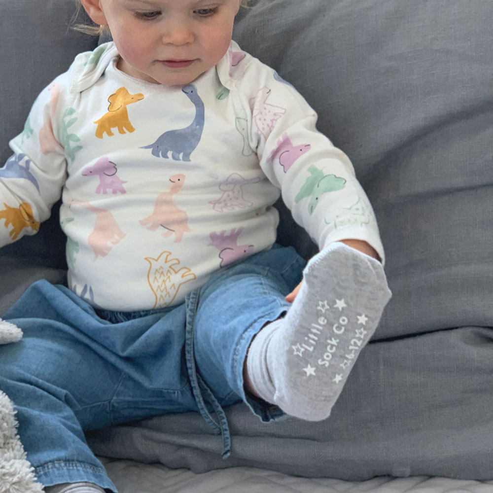 Young child sat with Little Sock Company socks