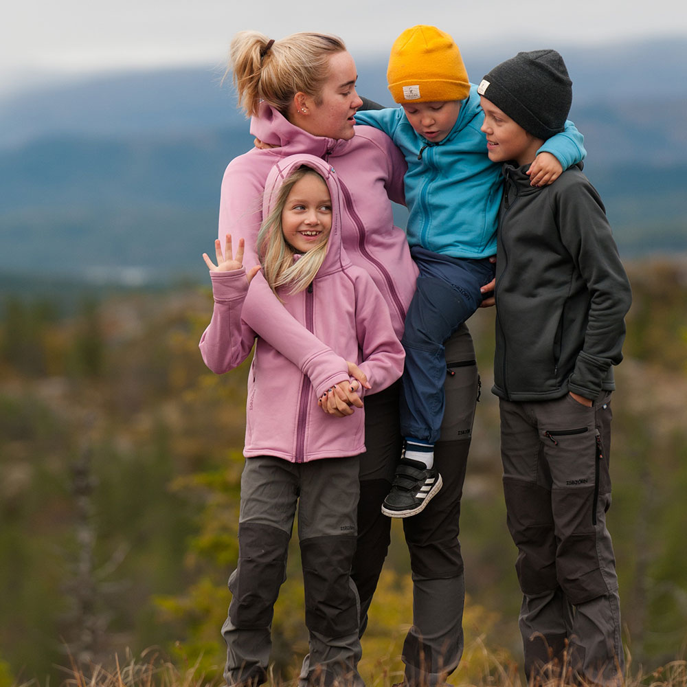 Family outside wearing Isbjorn Children's Clothing