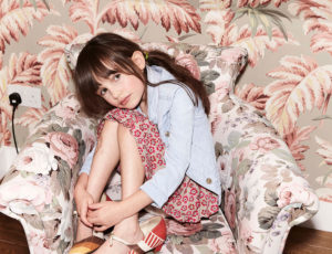 Young girl sat on patterned chair