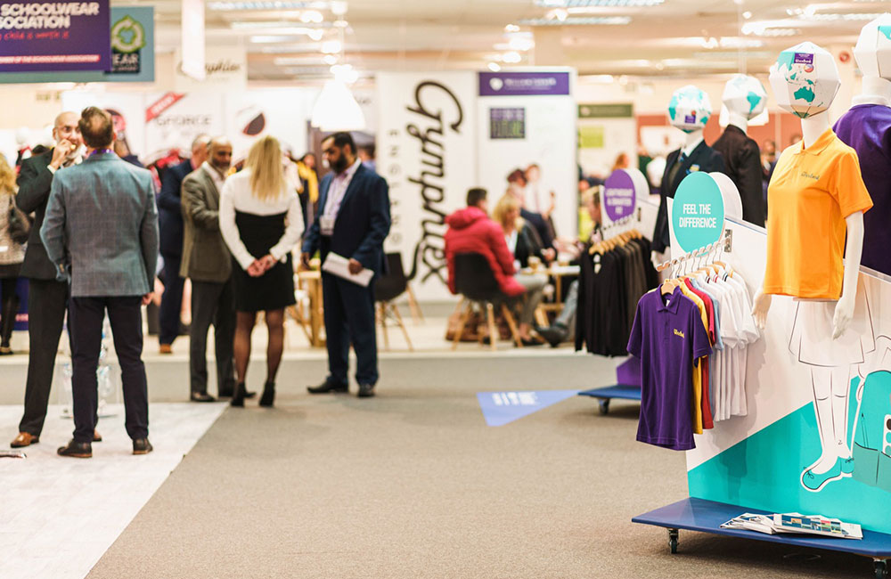 Exhibitors talking on stands at the Schoolwear Show