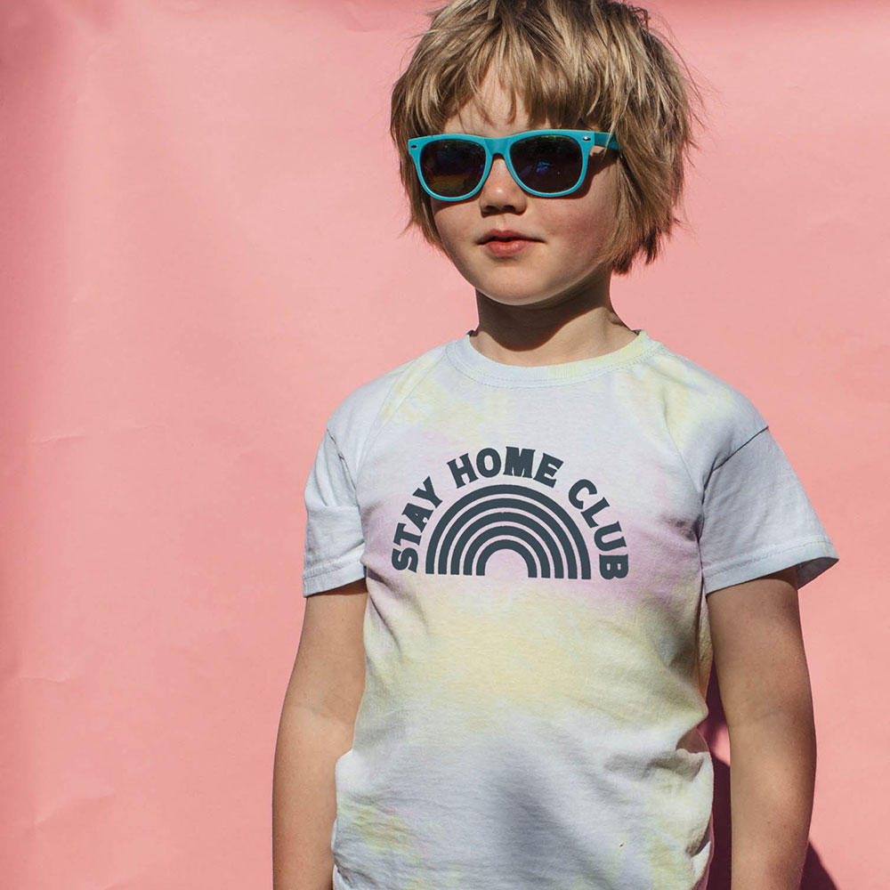 Young boy in white print WORD T shirt and sunglasses