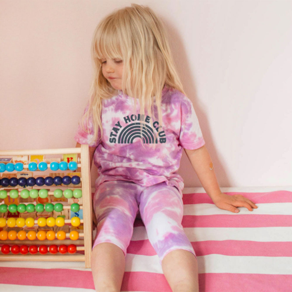 Young girl in tie-dyed WORD T Shirt and leggings