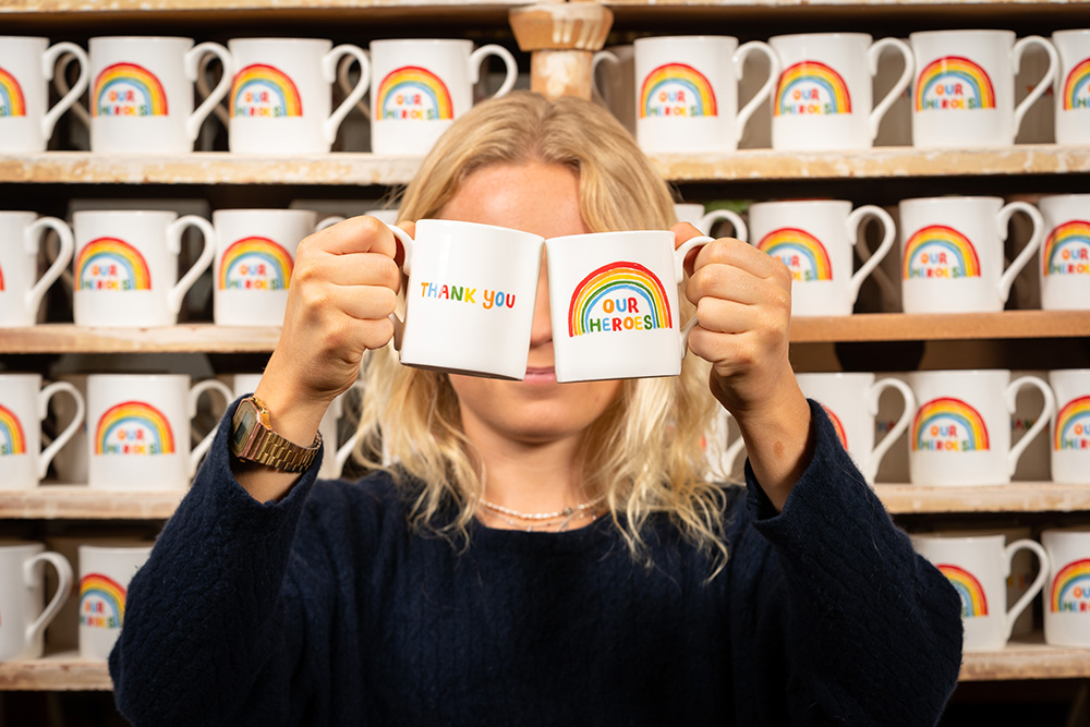 A lady holding limited edition china mugs