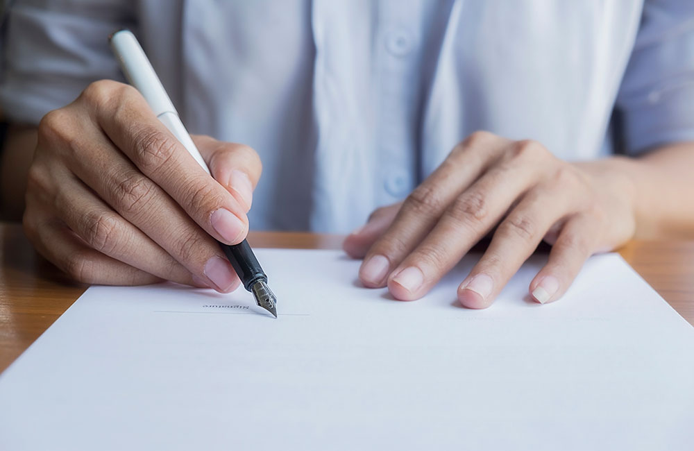 Man signing piece of paper