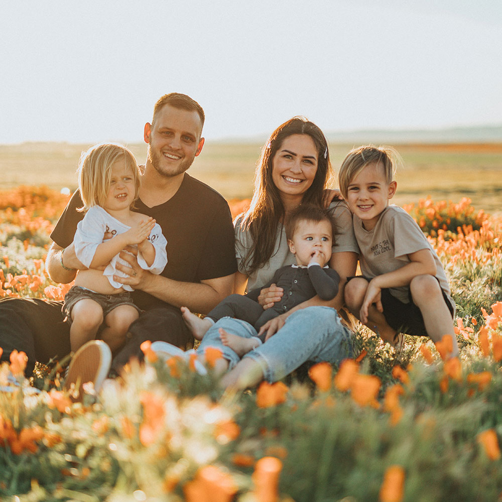 Environmentally conscious family sat together amongst flowers