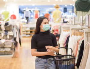 Young shopper wearing face mask in store