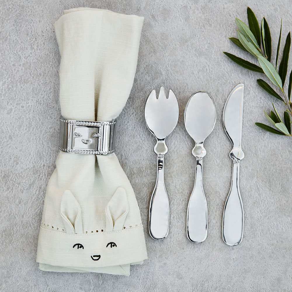children’s cutlery set, feeding spoon, and napkin ring made from hand-polished metal.