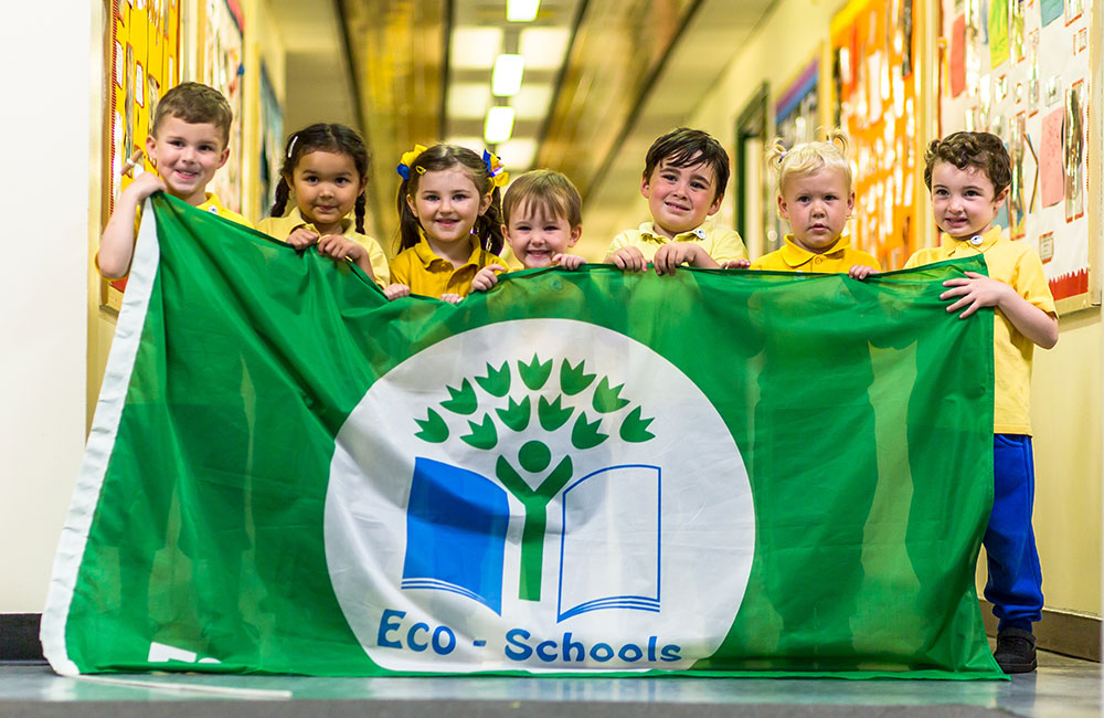 Frugi kids with green eco-schools banner