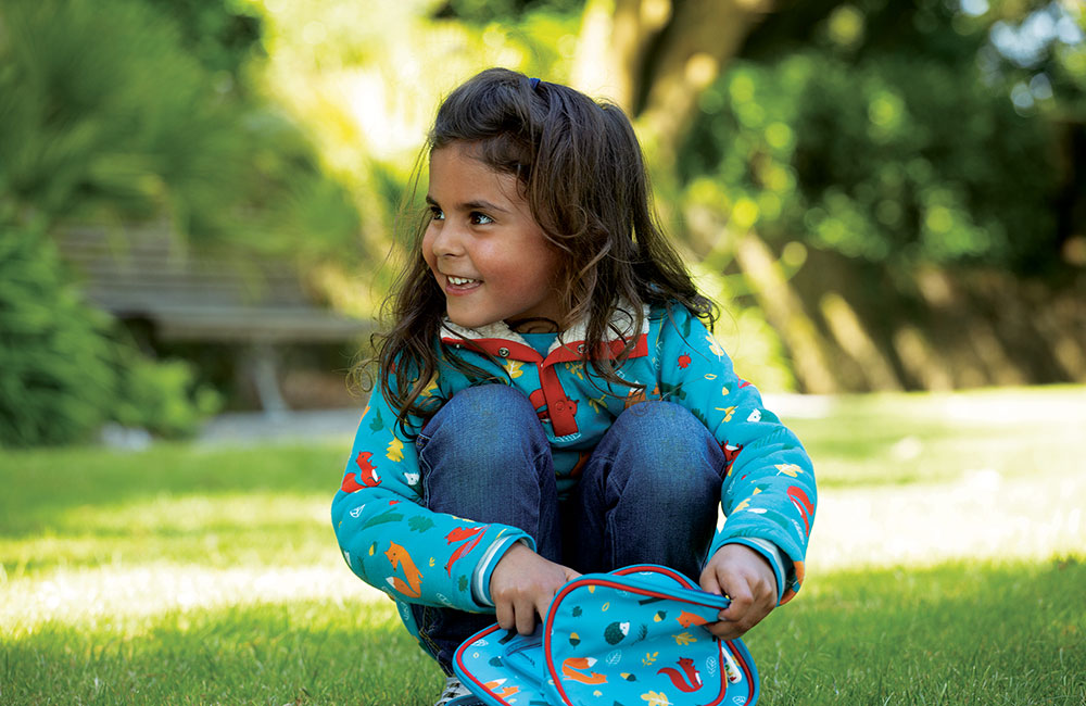 Young girl in Frugi's Woodland Trust range of kids clothing