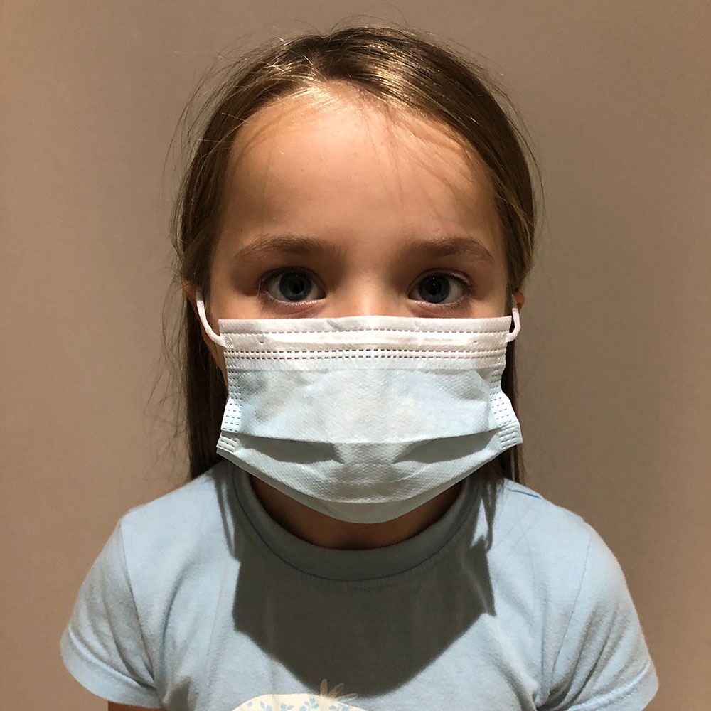 Young girl wearing protective face mask