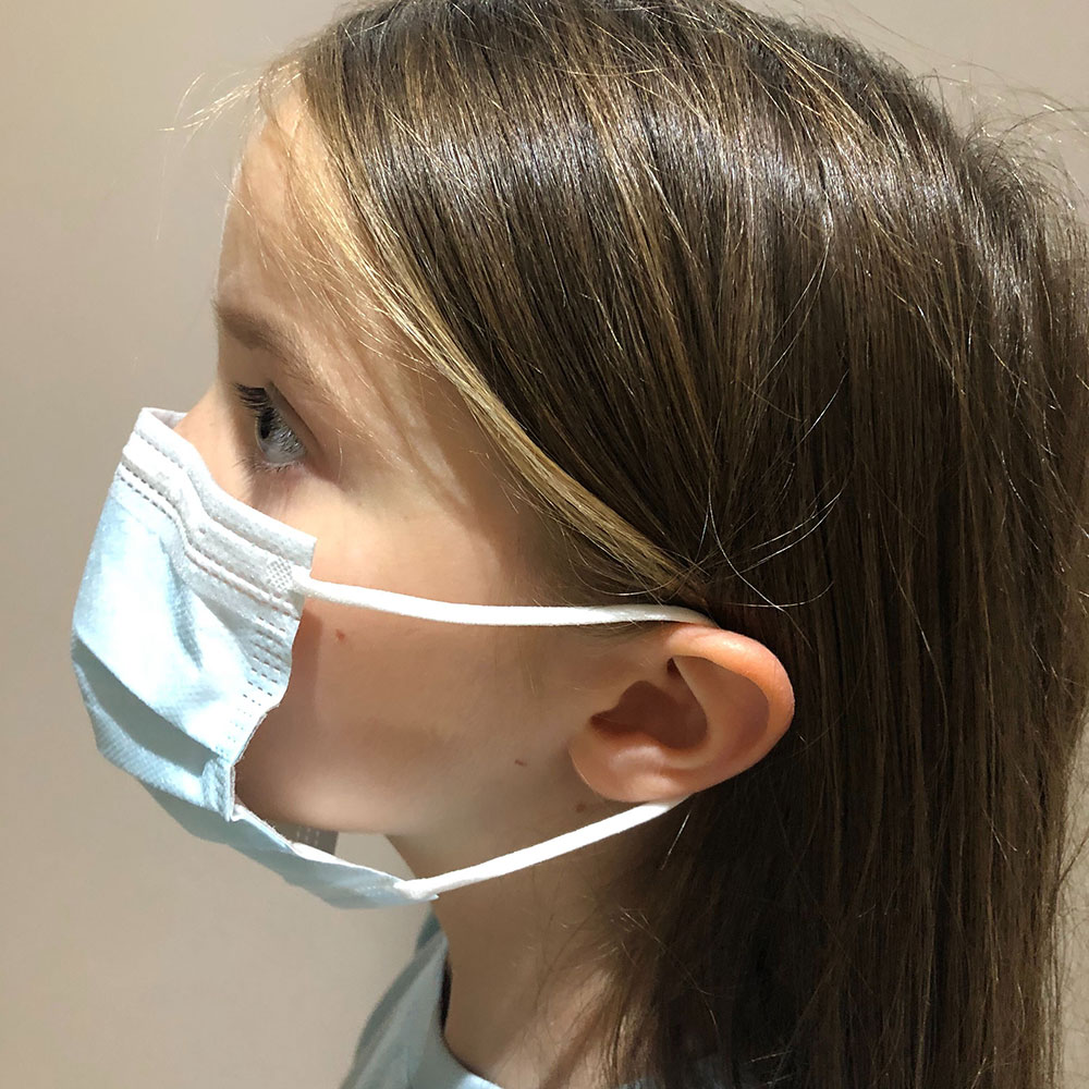 Young girl wearing protective face mask