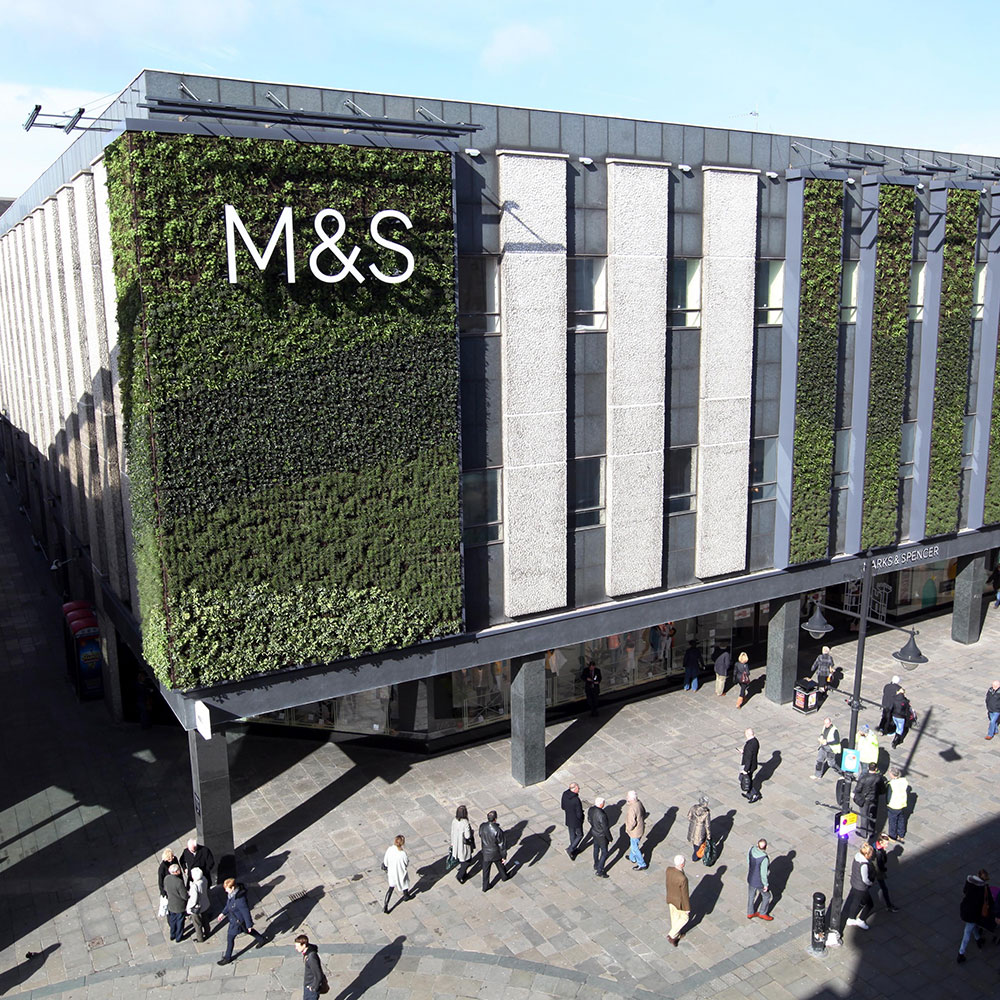 M&S building with sign on grass wall - Rainbow Sale