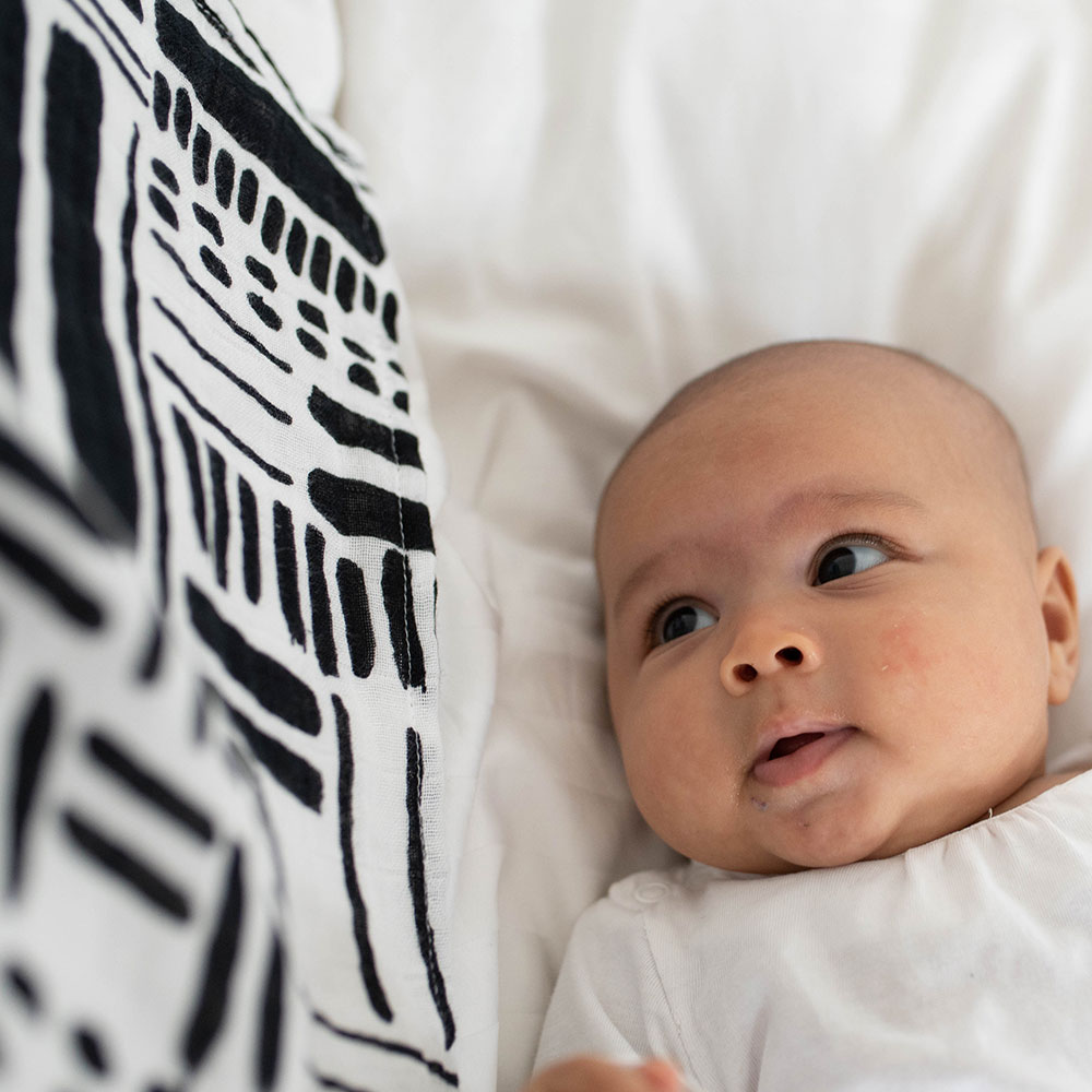 Baby next to Organic mono print muslin blanket