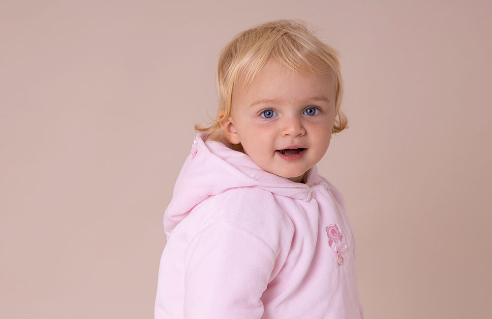 Baby girl in pastels pink hooded jacket