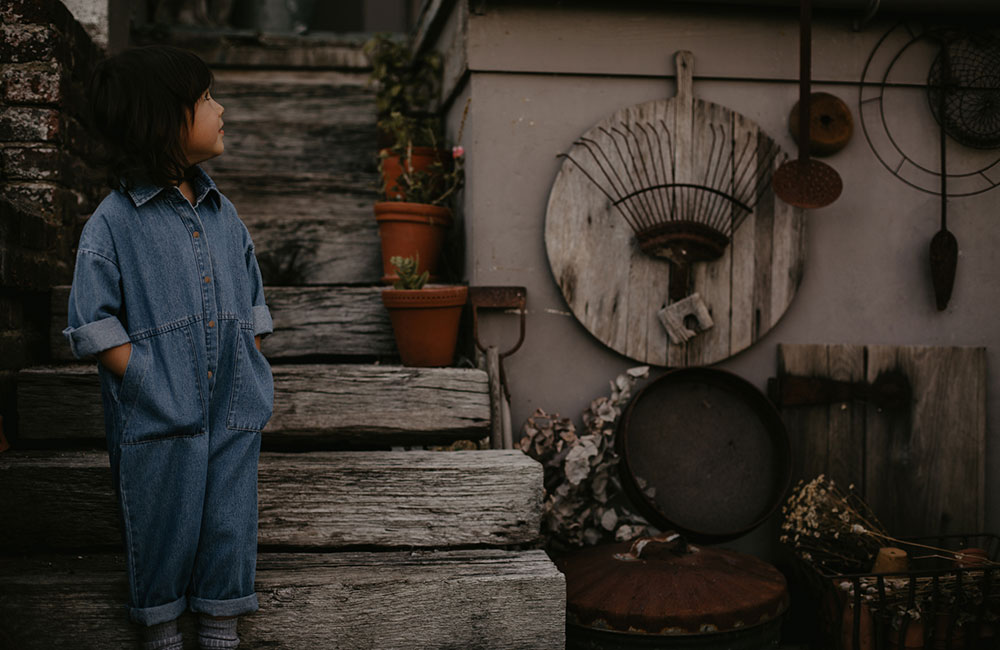 Young girl in denim dungarees