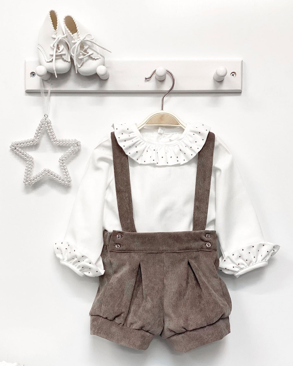 A child's outfit on a hanger
