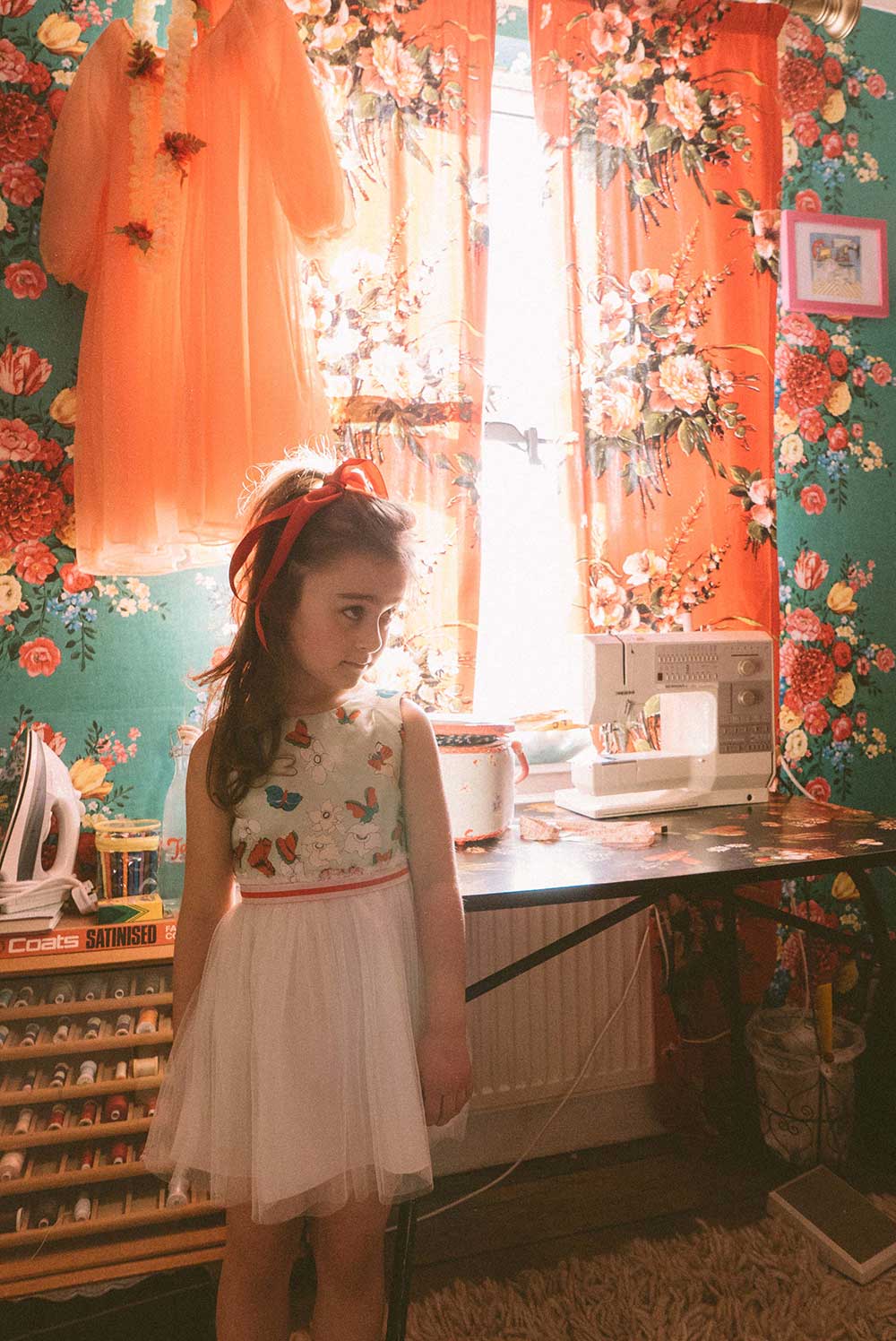 A girl wearing a flowery dress