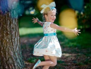A young girl dancing in the woods