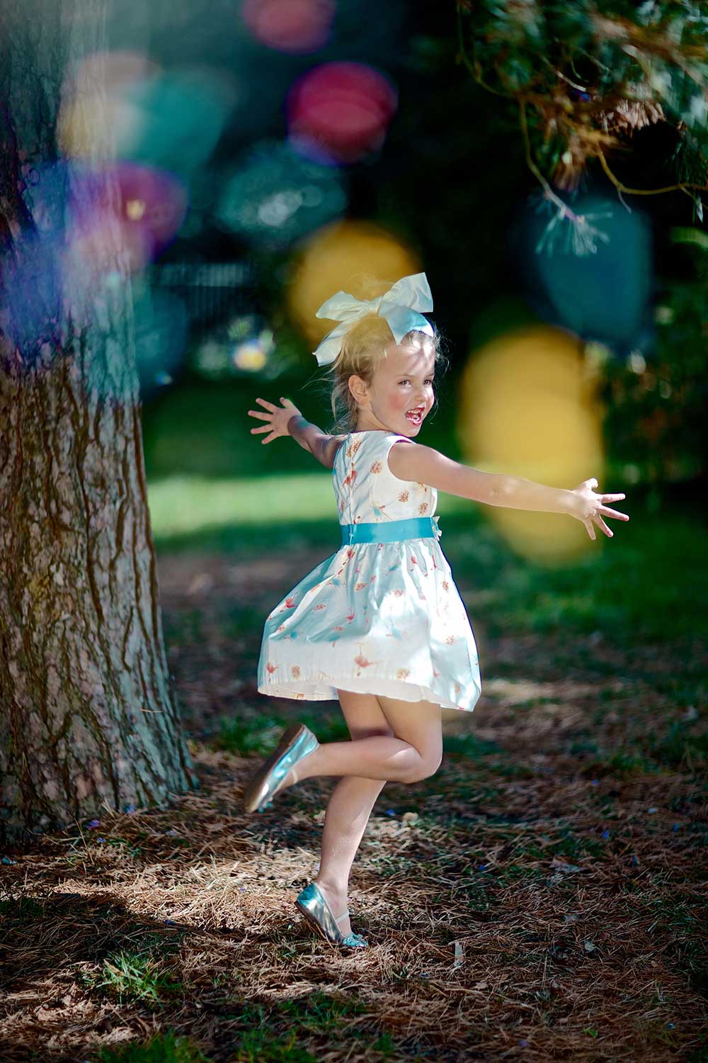 A young girl dancing in the woods