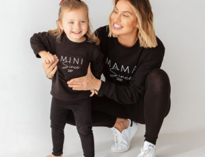 Mother and youg daughter in matching black Outfits