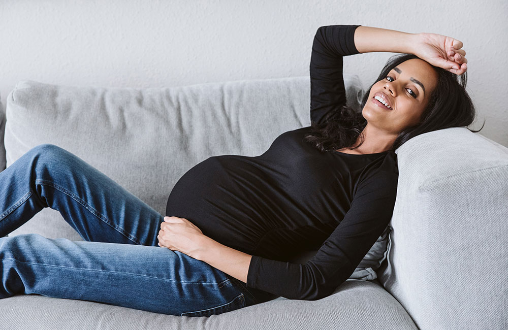 Pregnant lady laid resting wearling black top