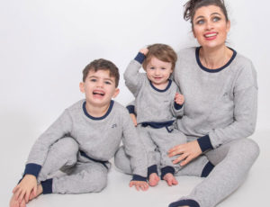 Mum and two young boys in matching pyjamas