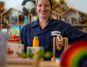 Business owner in her store with colourful wooden toys