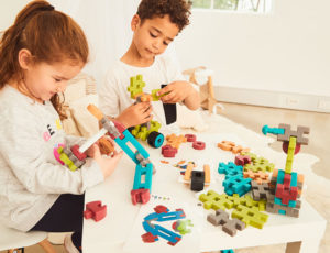 A young boy and girl playing with toys
