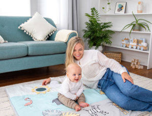 Mum and baby in living room on Aden + Anais baby mat