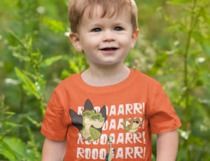 Young boy in orange Gigantosaurus dinosaur T Shirt