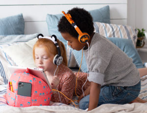 Young boy and girl listen to music in Planet Buddies earphones