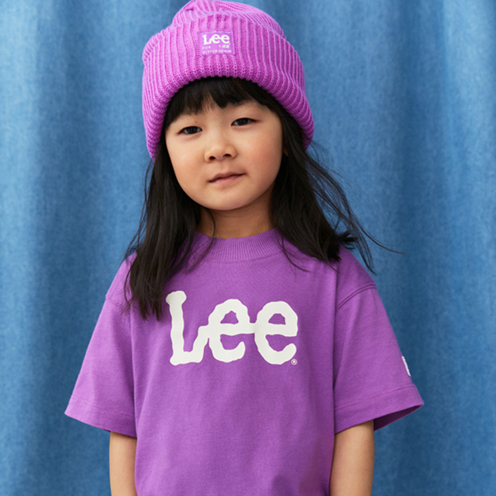 Girl in purple Lee branded T Shirt and hat